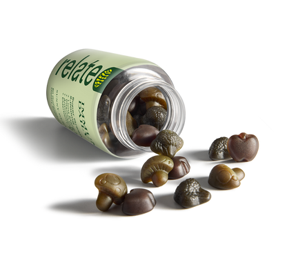 A 60-count bottle of sunny berry flavored gummies from the Relate brand, known as Immunity Daily, featuring a blend of super greens, lion's mane and reishi mushrooms, vitamin C and zinc, antioxidants, elderberry, and echinacea dietary supplements, spilled on a table