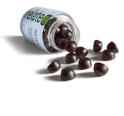 A bottle of Relate Mood Daily dietary supplements with 60 happy berry-flavored gummies, containing a super mushroom 10-plex blend to balance your mood, increase energy, and enhance focus spilled on a table